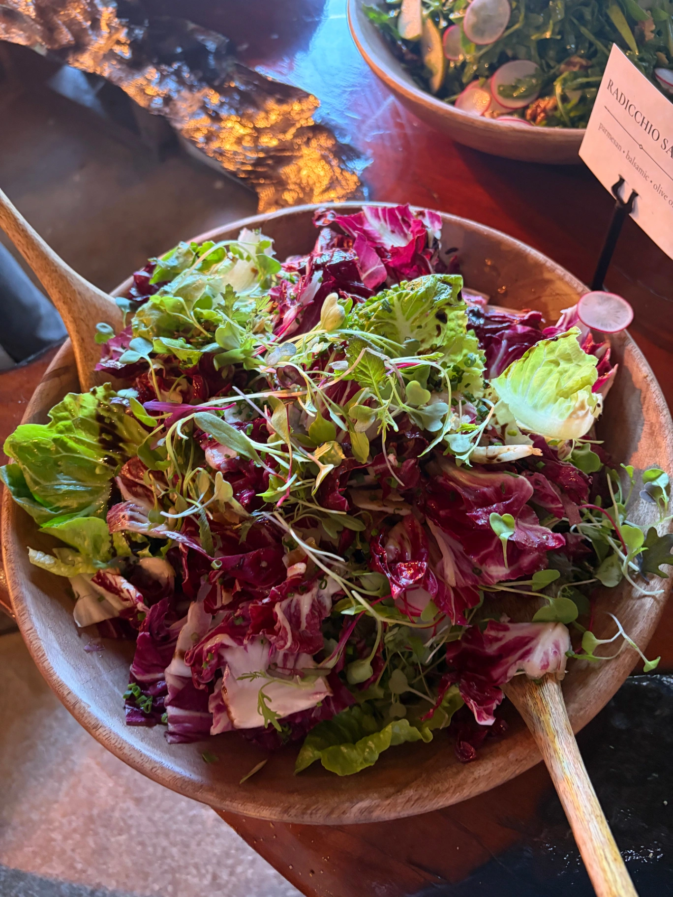Radicchio salad with microgreens in wooden bowl